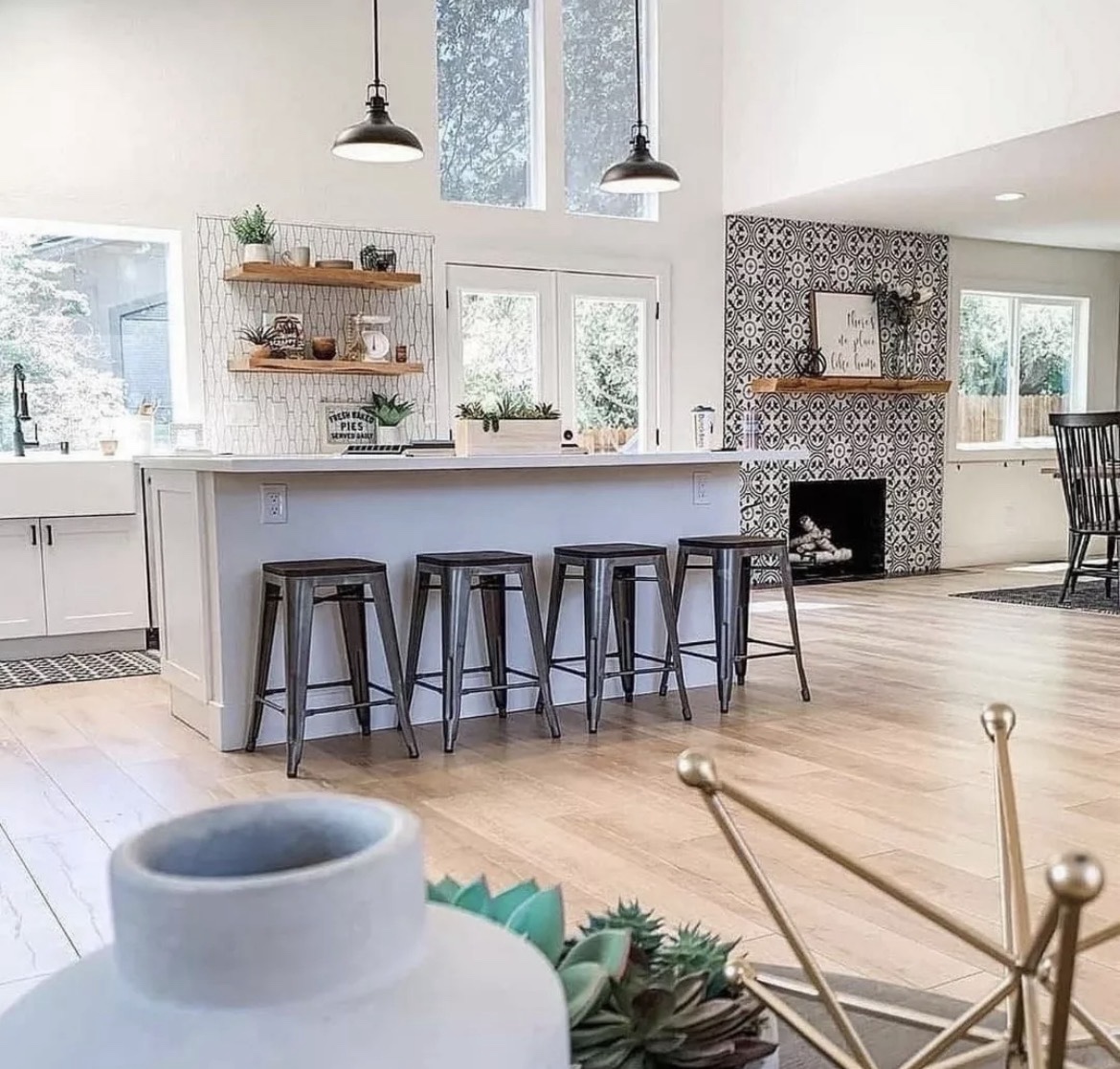 Bright remodeled kitchen with island and open dining area